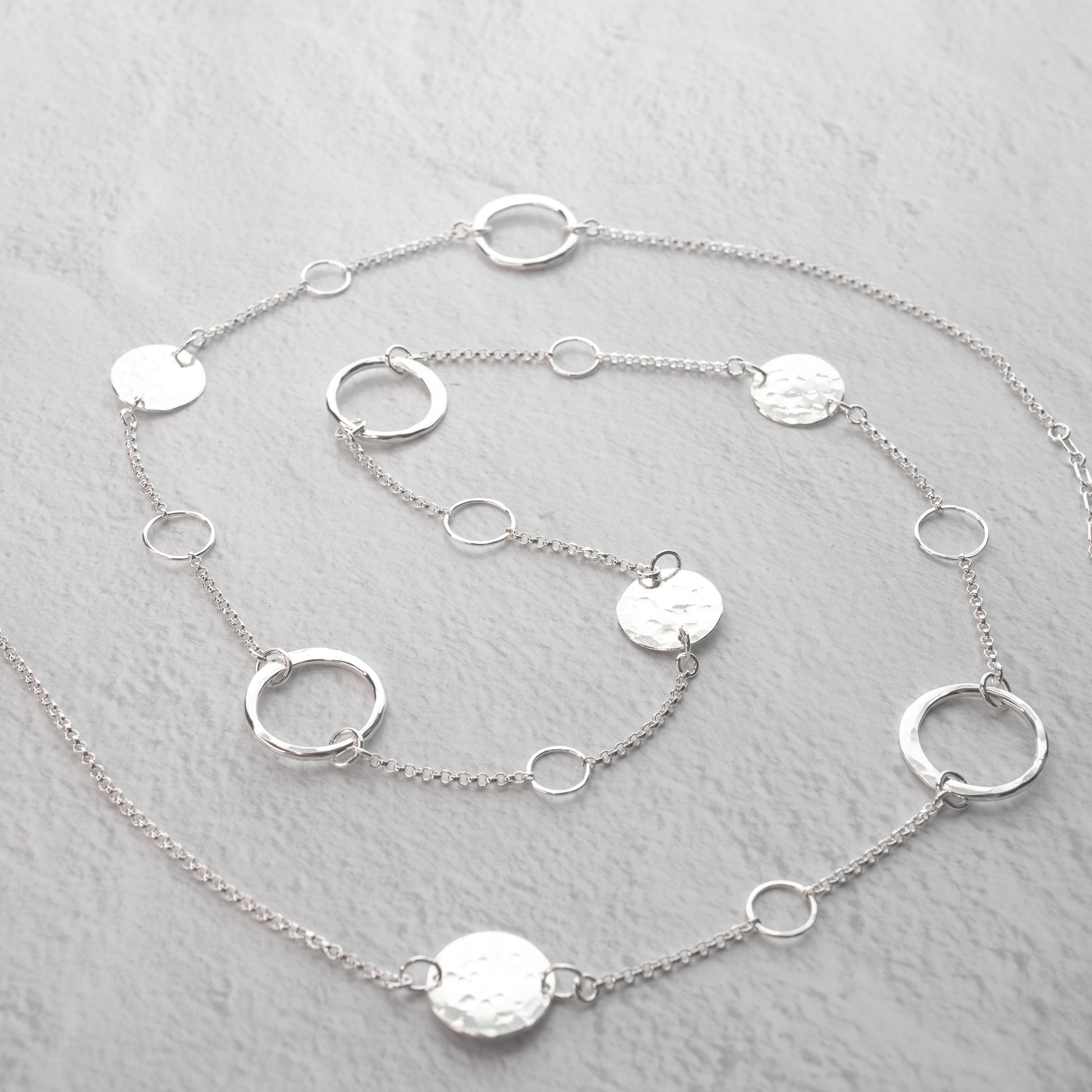 Handmade sterling silver Long station necklace with hand hammered details and forged artisan circle elements.  Unique handcrafted jewelry