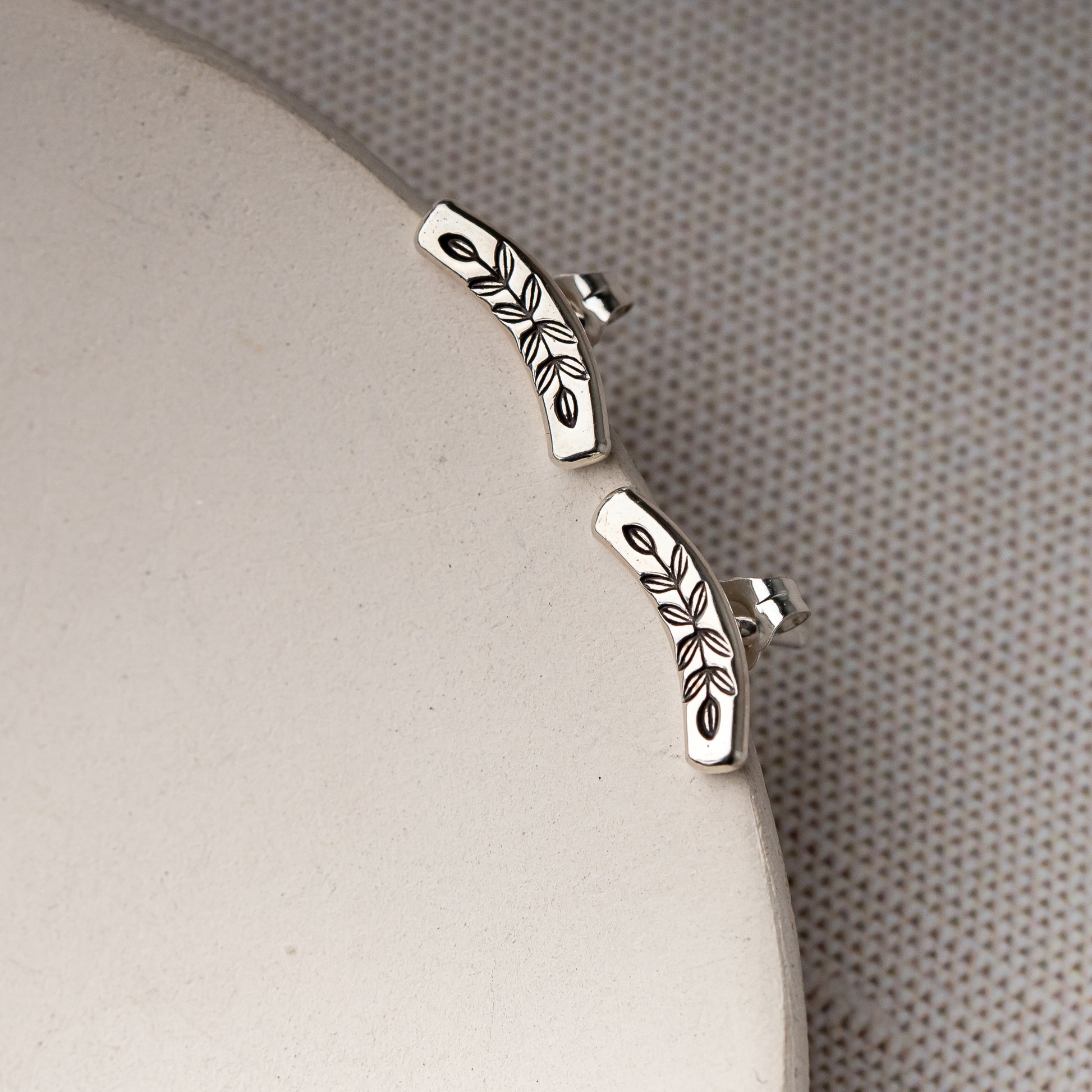 unique handmade jewelry featuring botanical details and a high polish shine with oxidized vine