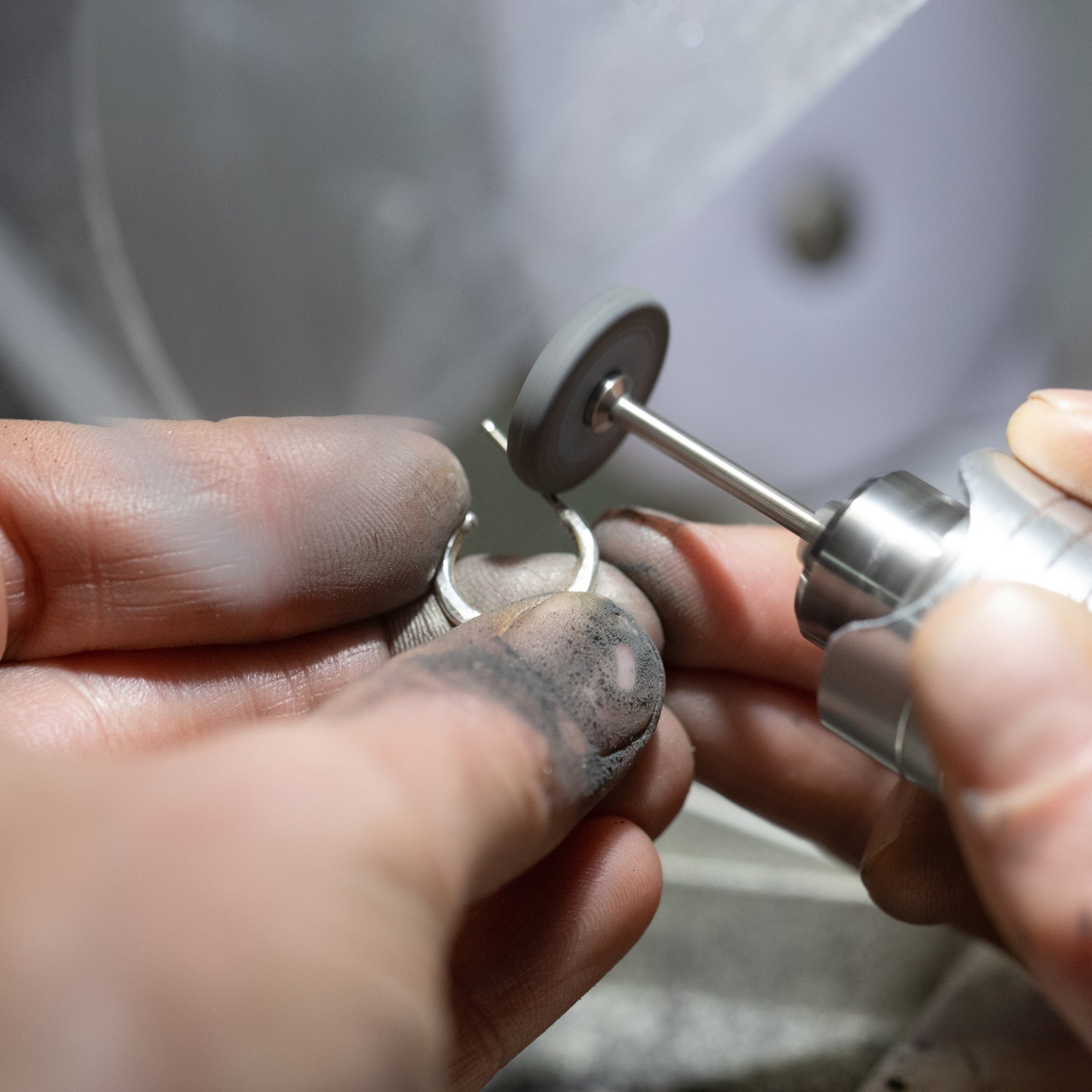 Handmade sterling silver jewelry needs lots of steps to make it the best it can be.  This shows a closeup of a handmade sterling silver hoop earring being polished up to a high shine.  Our jewelry is meticulously handmade in our home studio in Somers, Connecticut.