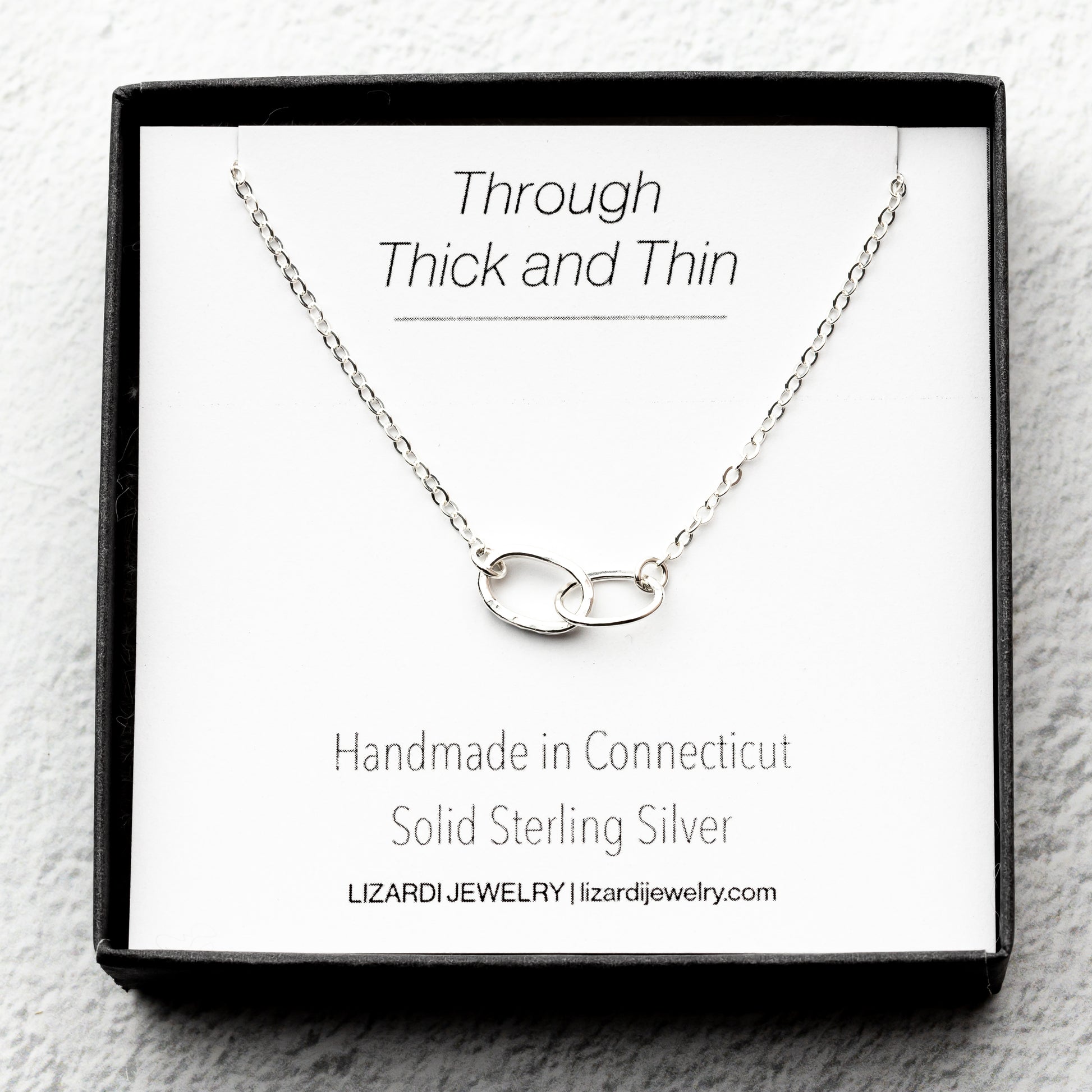 sterling Silver necklace with interlocking rings on a thick and thin sentimental card.