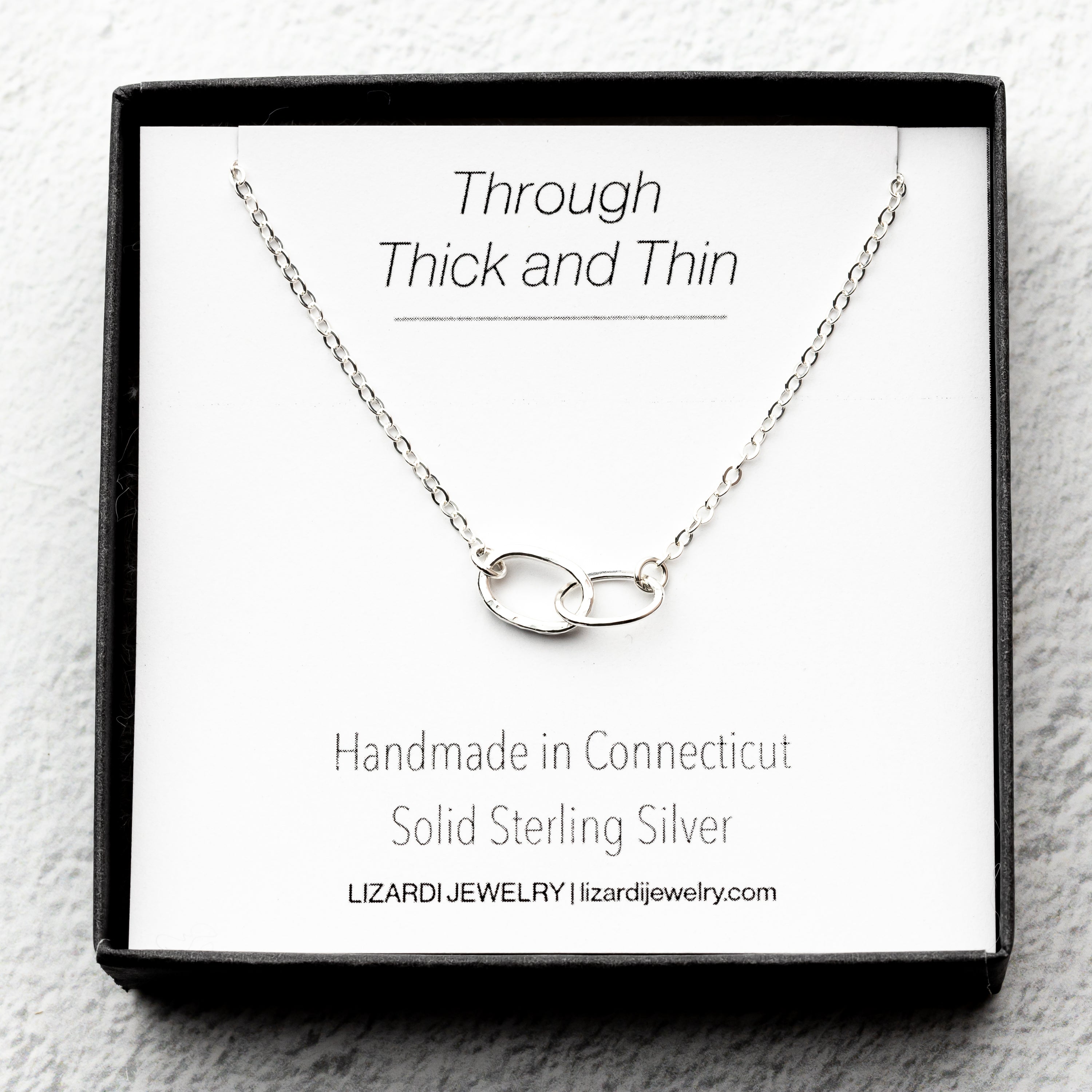 sterling Silver necklace with interlocking rings on a thick and thin sentimental card.