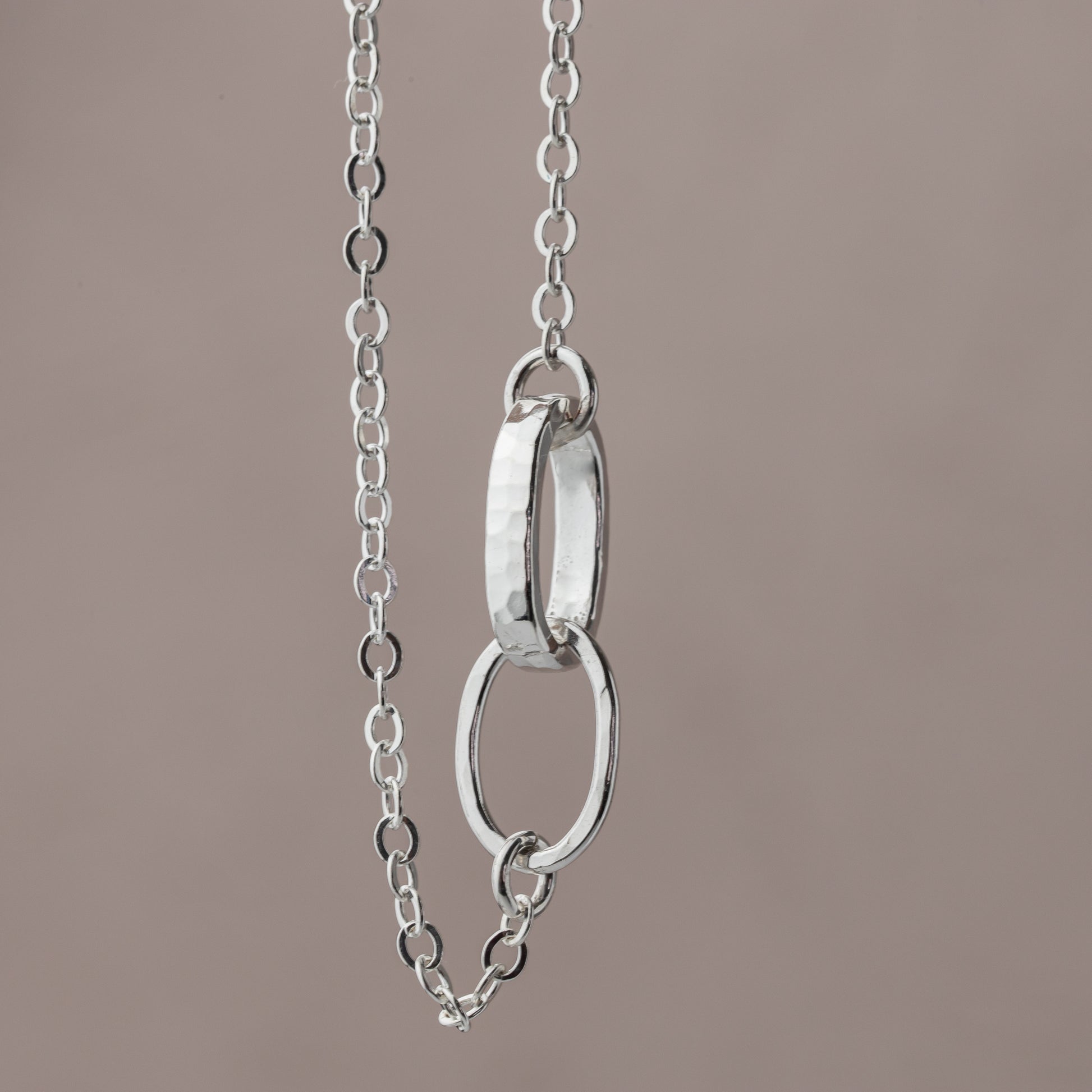 sterling silver chain with a unique interlocked thick and thin link center to symbolize the saying.  A thoughtful jewelry gift for her