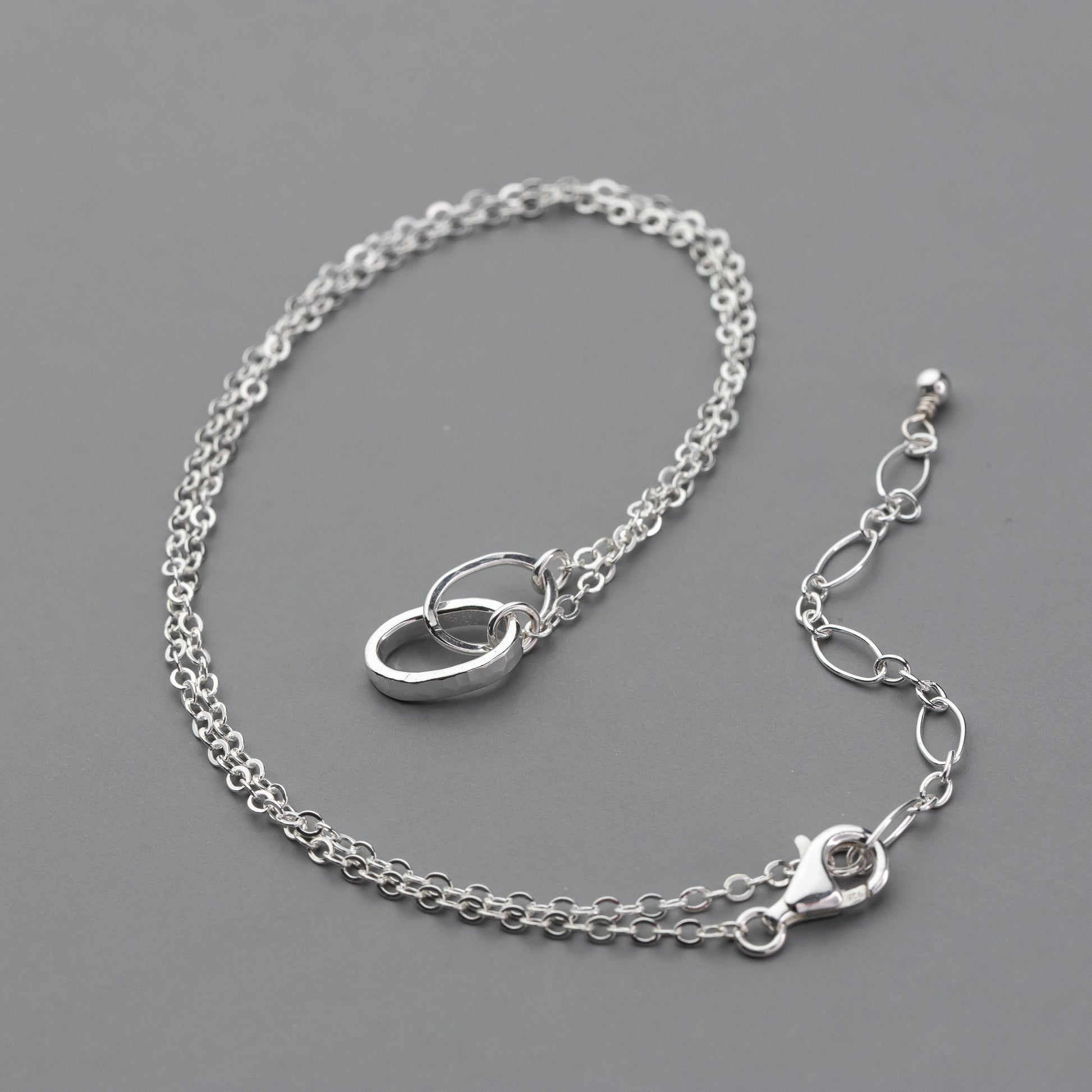 sterling silver chain necklace on a gray background