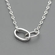 sterling Silver necklace with interlocking rings on a gray background