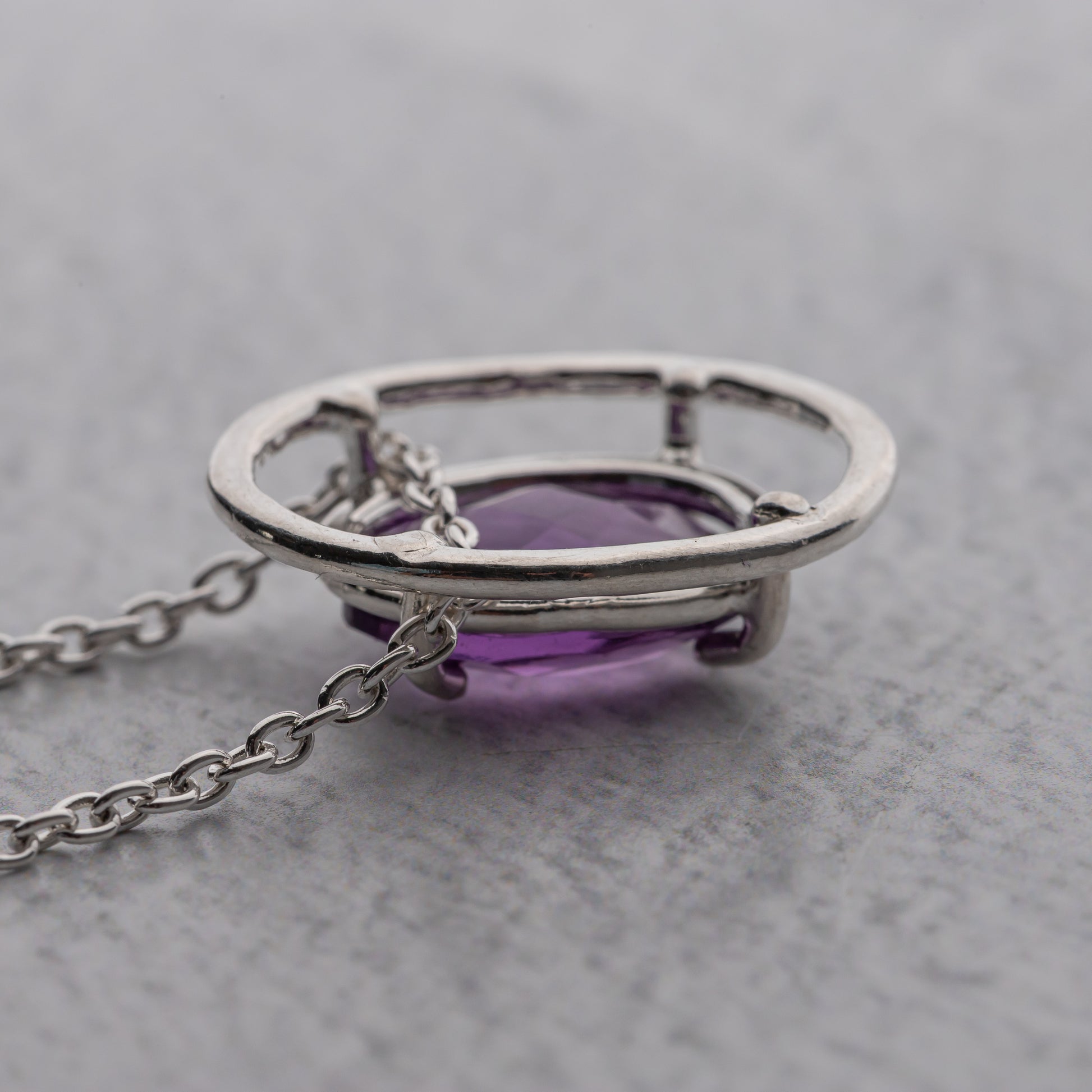 sterling Silver necklace with a purple gemstone on a gray background