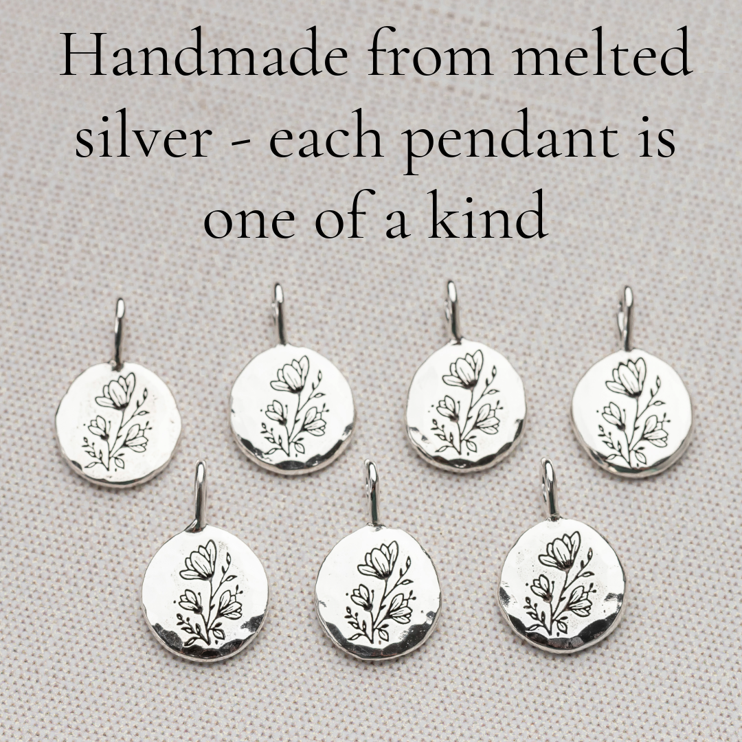 Solid sterling silver pendant with hammered texture and floral engraving
