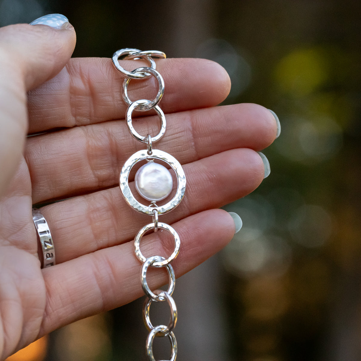 natural freshwater coin pearl bracelet is accented with handmade Argentium Sterling Silver links in a beautifully textured hammered finish.  This unique design features a toggle clasp for an adjustable chain
