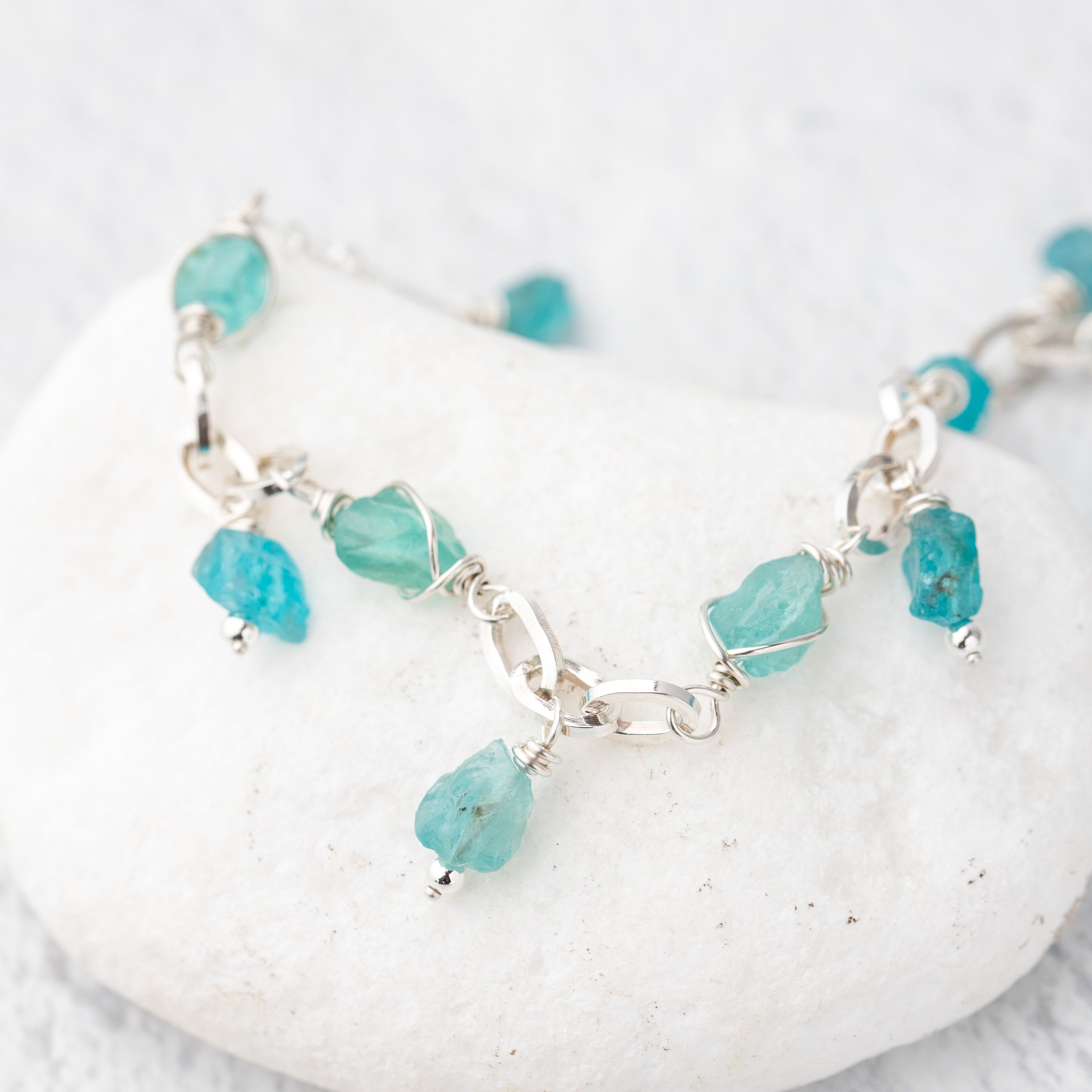 Unique Handmade Sterling Silver and raw stone bracelet with wire wrapped charm dangles.