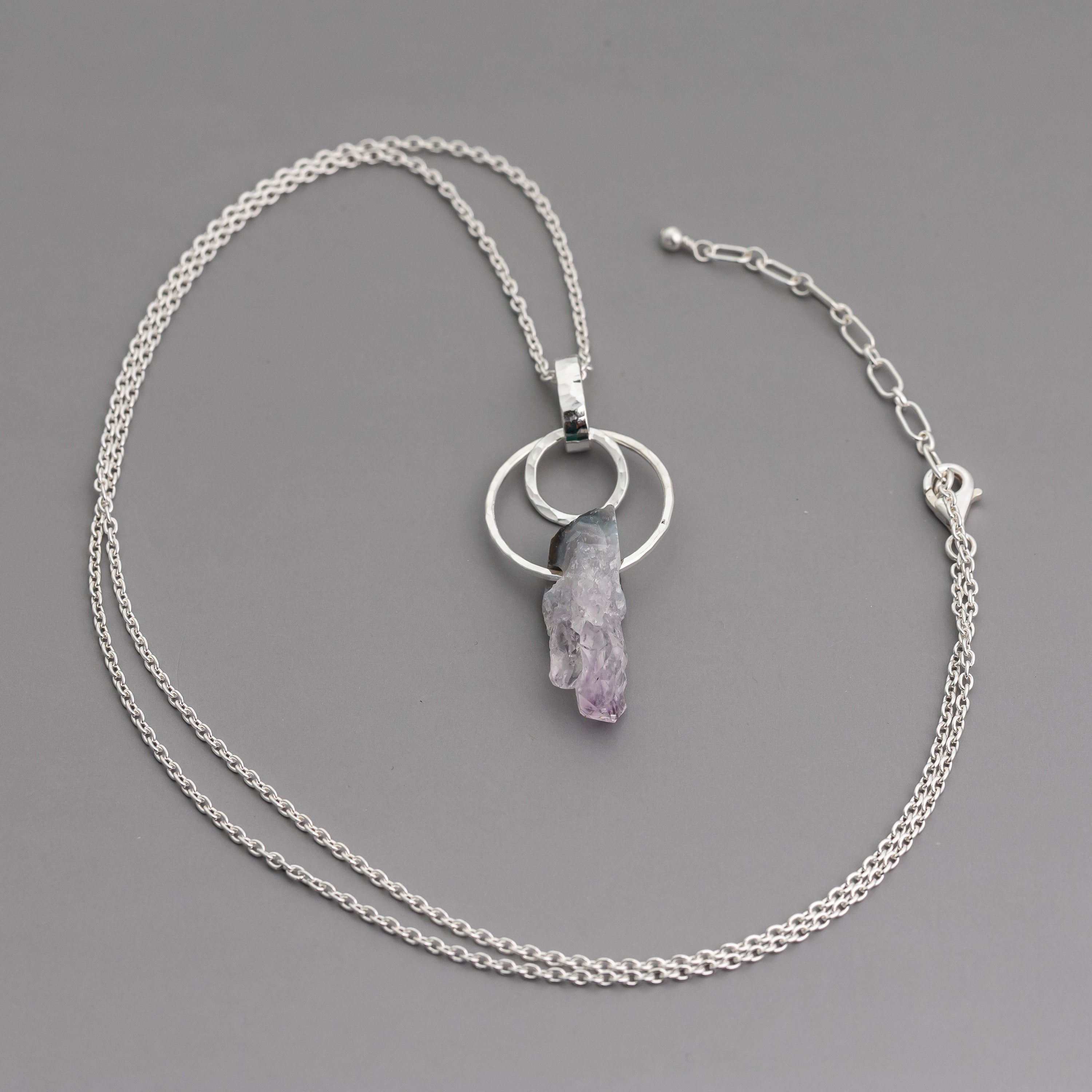 handmade raw crystal necklace with sterling silver circles and an amethyst stalactite slice