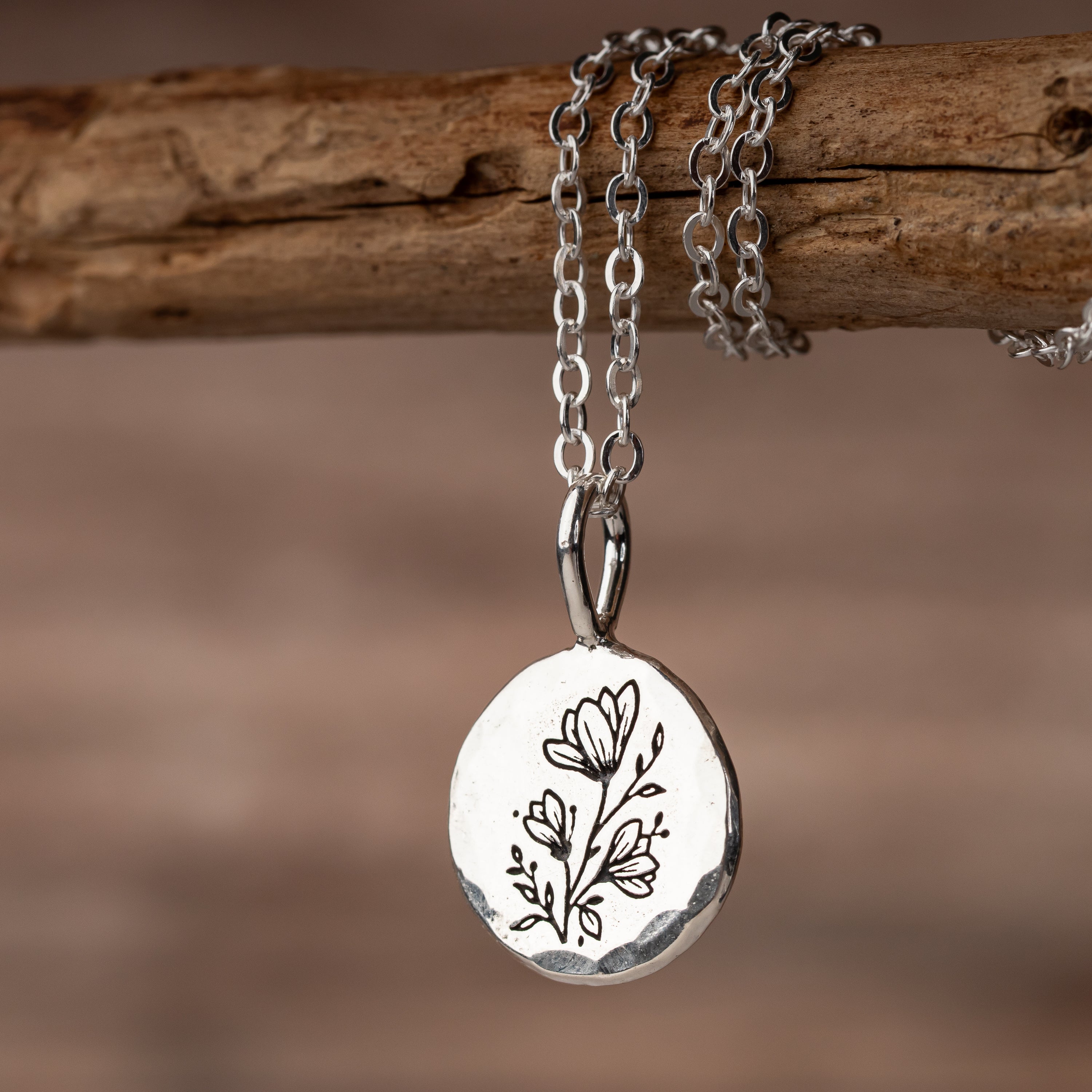 Solid sterling silver pendant with hammered texture and floral engraving